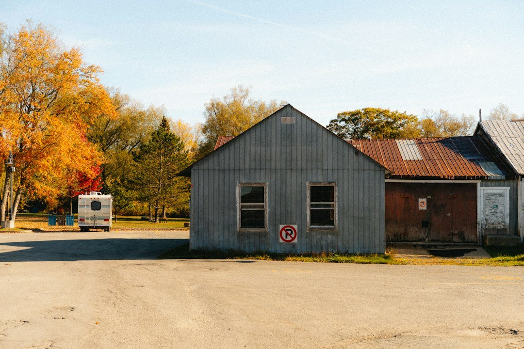 Metal building surrounded by autumn trees