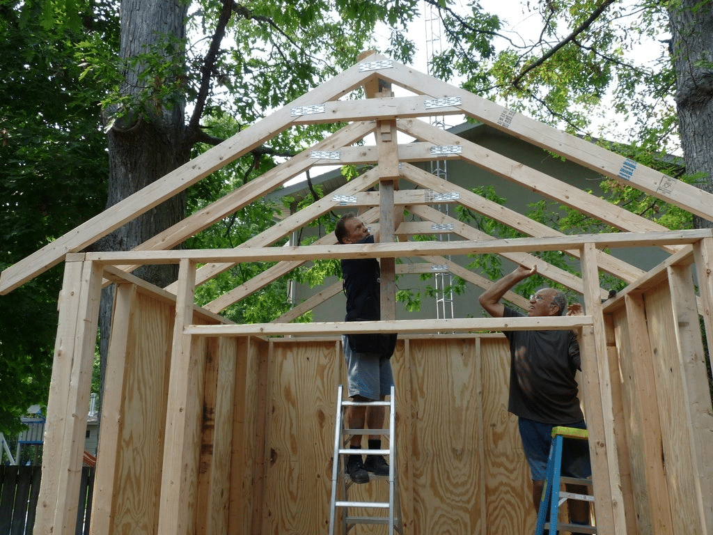 two men building shed