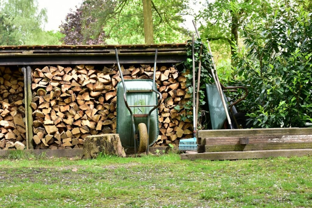 Split firewood stacked neatly under a roofed firewood shed